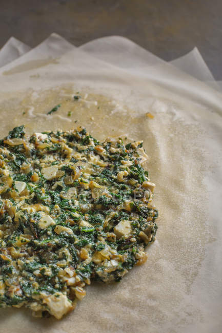 Stuffing for traditional spanakopita spinach pie on filo dough — Stock Photo