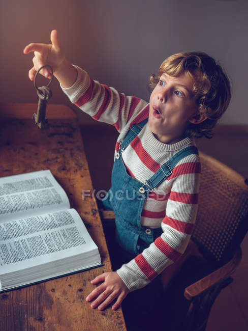 Boy holding vintage keys — Stock Photo