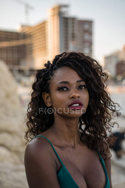Retrato de mulher negra com cachos em pé ao ar livre — Fotografia de Stock