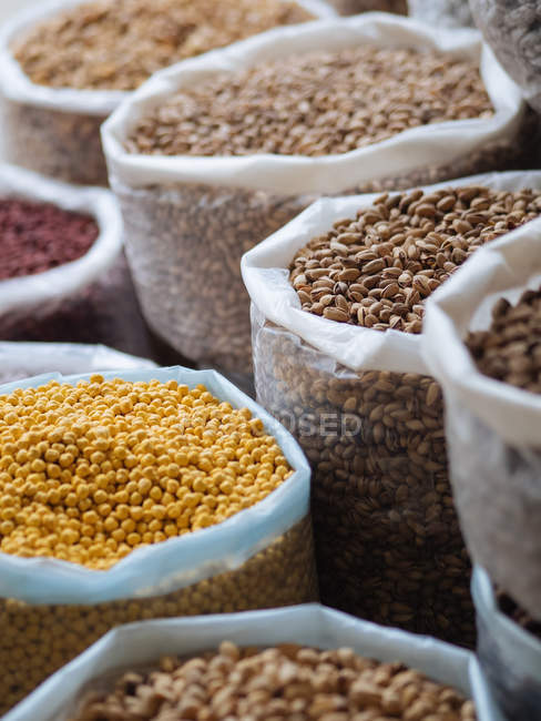Bags filled with various grains and aromatic spices and condiments at farmer market — Stock Photo