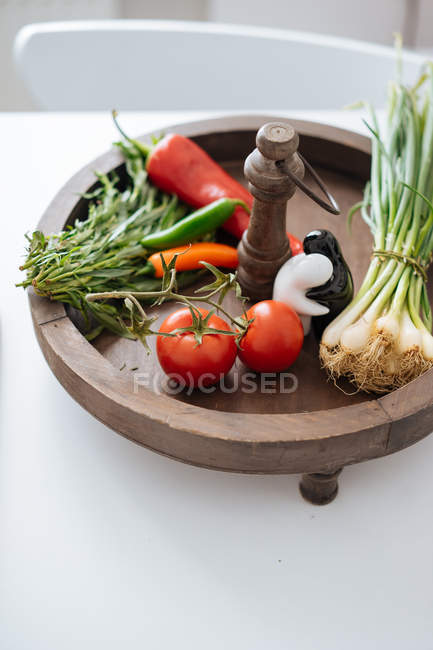 Fresh vegetables and herbs in wooden bowl — Stock Photo