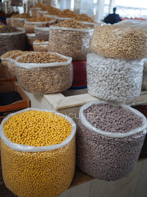Bolsas llenas de diversos granos y especias aromáticas y condimentos en el mercado de los agricultores - foto de stock