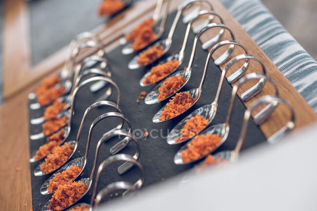 Bright appetizers on spoons — Stock Photo
