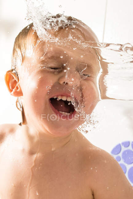 Adorable little child playing in bathtub — Stock Photo