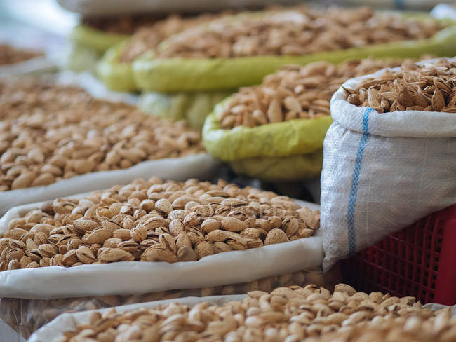Stoffbeutel gefüllt mit getrockneten Mandeln auf Bauernmarkt — Stockfoto