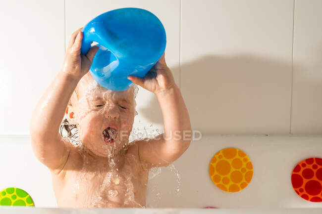 Adorable little child playing in bathtub — Stock Photo