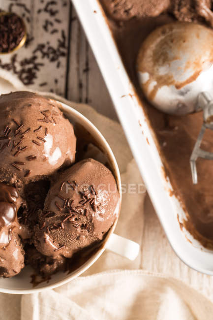 Close-up of Homemade chocolate ice cream in bowl and in box — Stock Photo