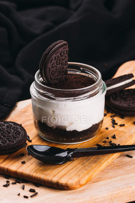 Sweet dessert with mousse and chocolate cookies on wooden board — Stock Photo
