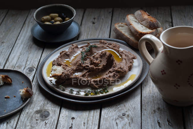 Lentil pate on plate on rustic wooden table — Stock Photo