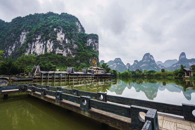 Vista panorâmica de piso de madeira no rio Quy Son em pequeno porto com montanhas, Guangxi, China — Fotografia de Stock