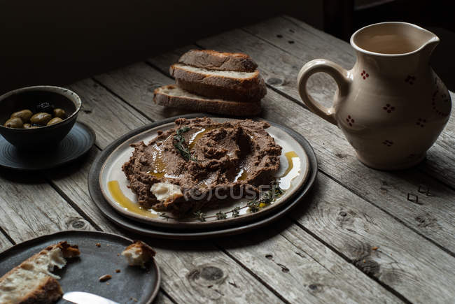 Lentil pate on plate on rustic wooden table — Stock Photo