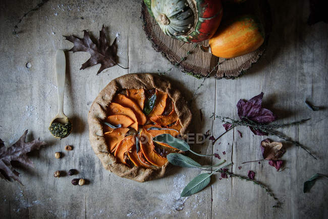 Delicious baked pumpkin galette with sweet onion on rustic wooden table — Stock Photo