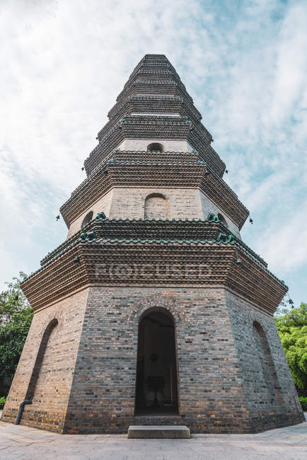 Exterior of brick old tower in oriental style under cloudy sky in Qingxiu Mountain, Nanning, China — Stock Photo