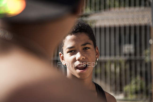 Afro young boy with earring with mouth open outdoors — Stock Photo