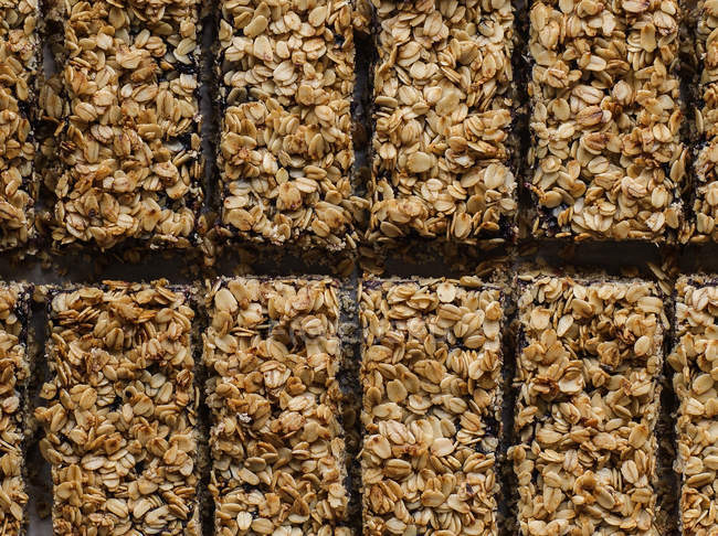 Sabrosas barras rectangulares de cereales en filas - foto de stock