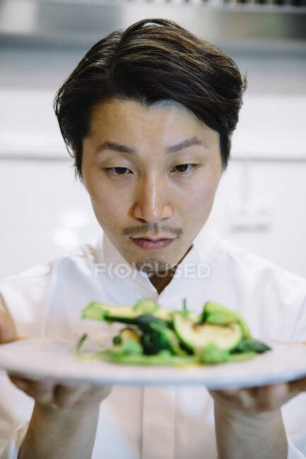Japanese cook with food plate — Stock Photo