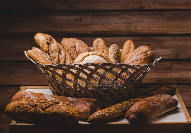 Composición de panes frescos en canasta - foto de stock