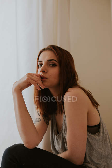 Portrait of young woman leaning on hand — Stock Photo