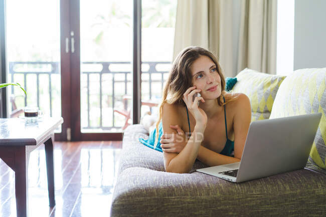 Woman lying on couch — Stock Photo