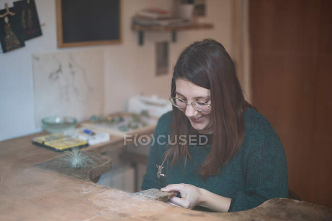Женщина вырезает украшения из коры — стоковое фото