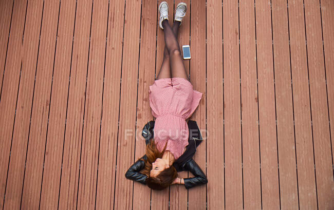 Young woman lying on floor — Stock Photo