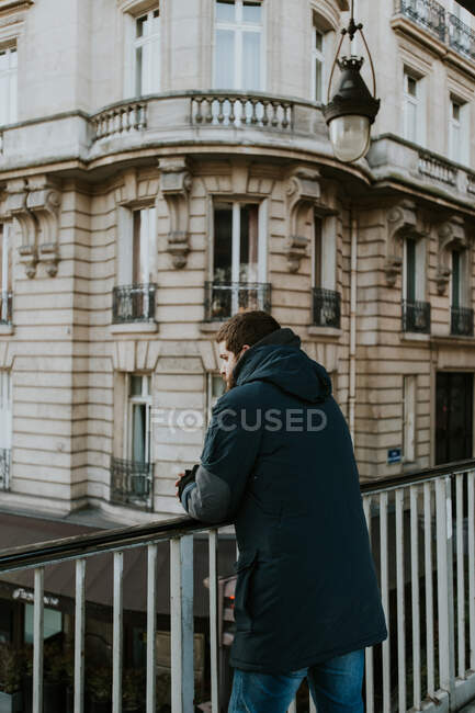 Man leaning on handrail on street — Stock Photo