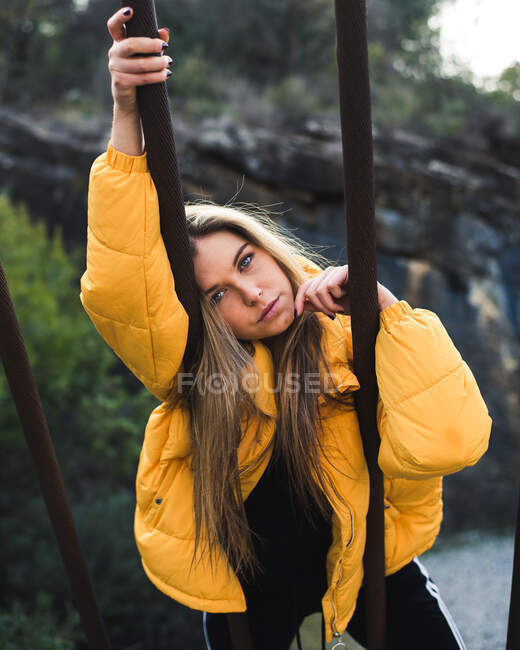 Beautiful lady leading on brown beams — Stock Photo