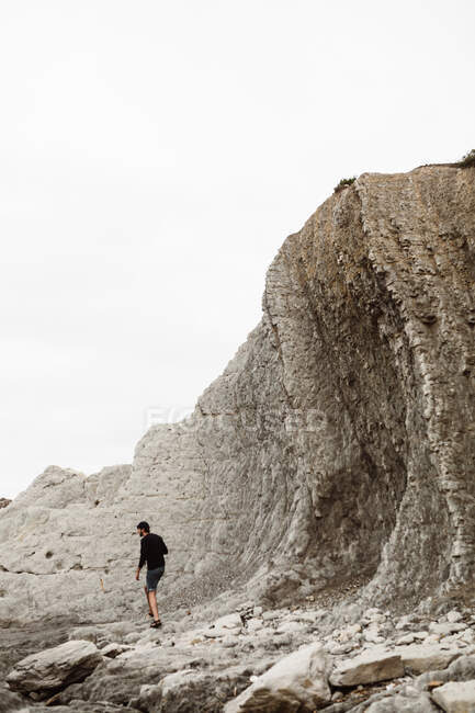 Back view of male walking between mountains, looking away in Cantabria, Spain — Stock Photo