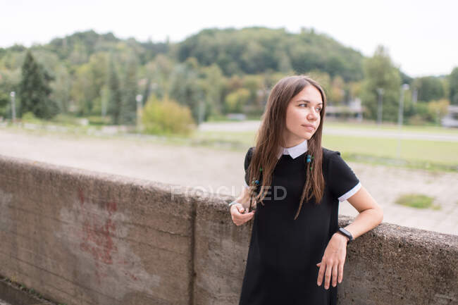 Junge stilvolle Frau im schwarzen Kleid im Freien — Stockfoto