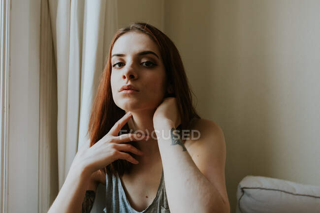 Young woman looking at camera at home — Stock Photo