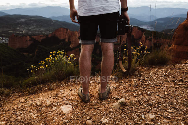 Crop man sitting at picturesque landscape — Stock Photo