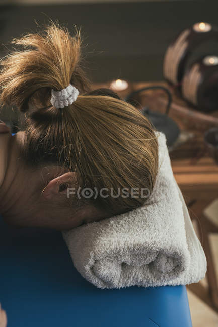 Mulher deitada na mesa na sala de massagem — Fotografia de Stock