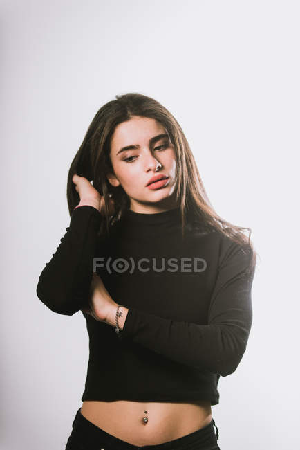 Girl in black turtle neck sweatshirt posing on grey background — Stock Photo