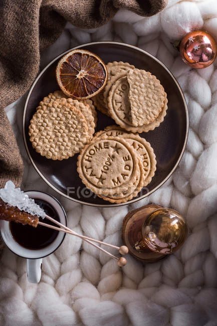 Biscoitos caseiros saborosos e xícara de café em xadrez com enfeites de Natal — Fotografia de Stock