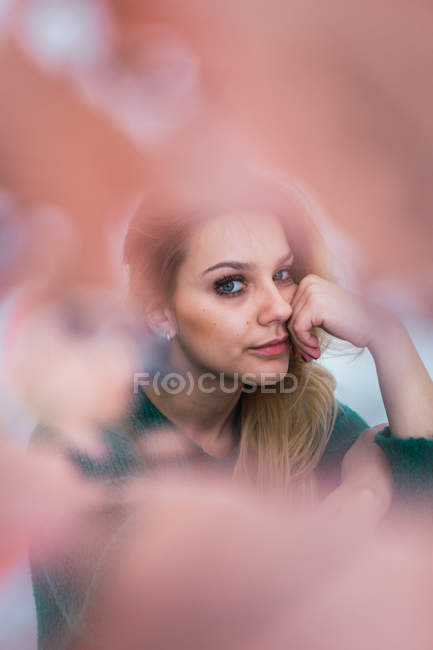 Pensive blonde girl in sweater looking at camera — Stock Photo