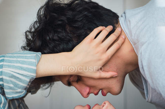 Tender couple lying on bed face to face — Stock Photo