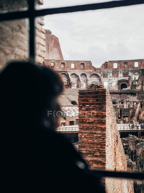 Person looking at ruins from window — Stock Photo