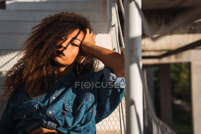 Portrait of african american young woman in denim shirt in sunlight — Stock Photo