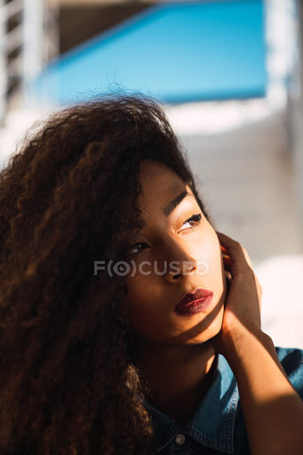 Portrait of African American dreamy woman in sunlight — Stock Photo