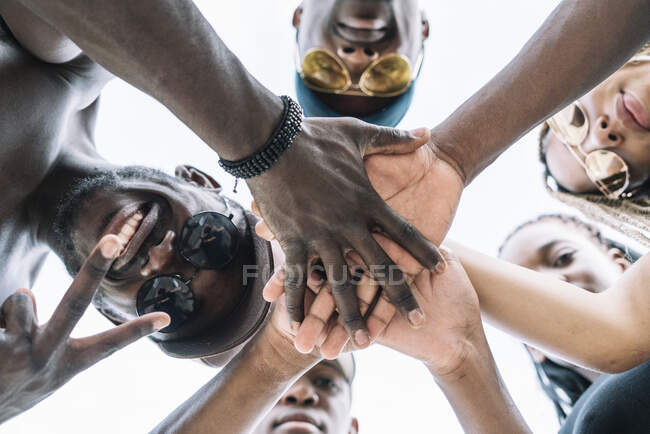 Group of friends stacking hands — Stock Photo