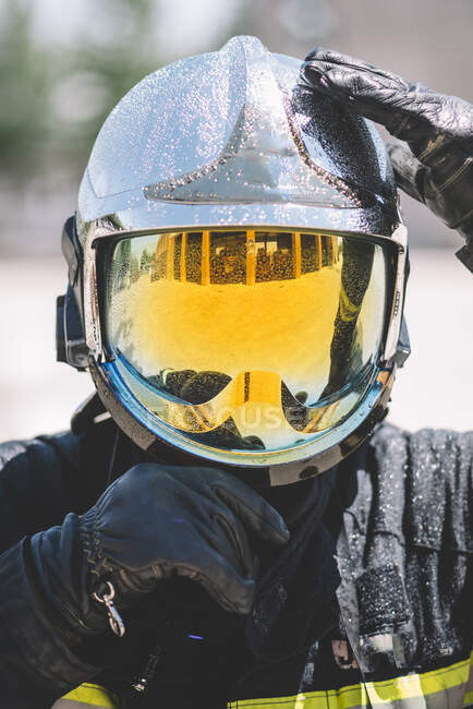 Firefighter poses with helmet looking at camera. — Stock Photo