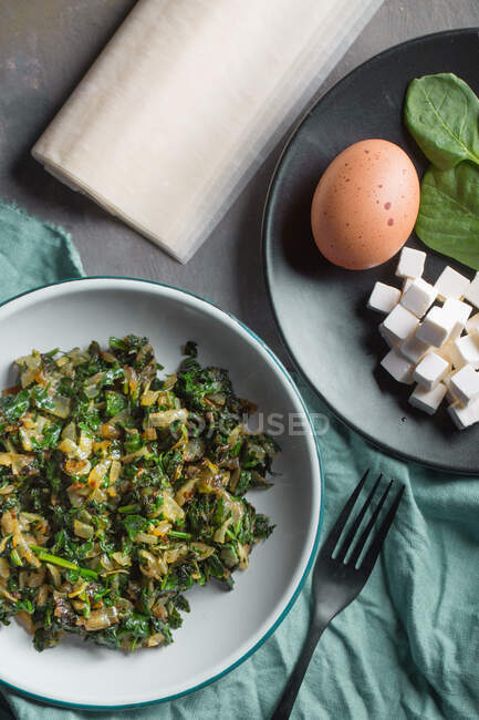 View of two plates with a dish of eggs and vegetables — Stock Photo