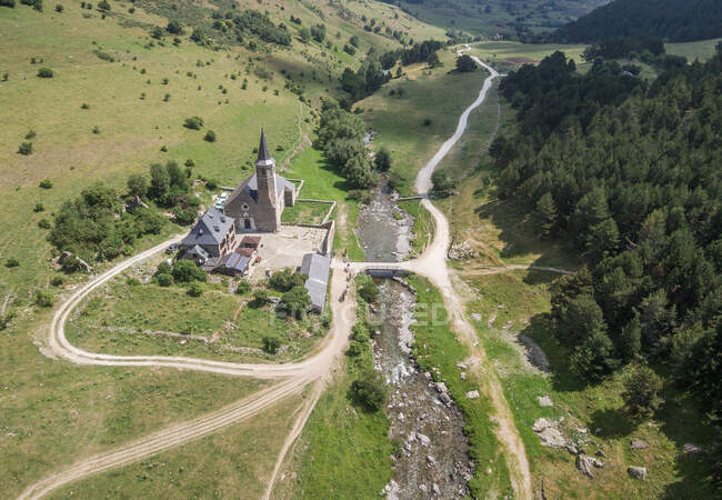 Drone view of beautiful landscape with church on creek surrounded with green forest, Asturias — Stock Photo