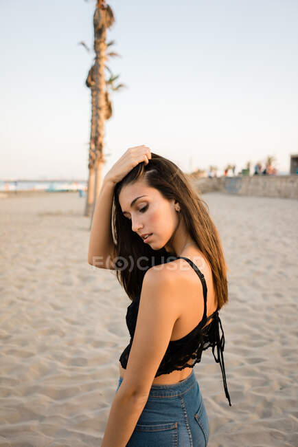 Atemberaubende brünette Frau posiert am Strand — Stockfoto