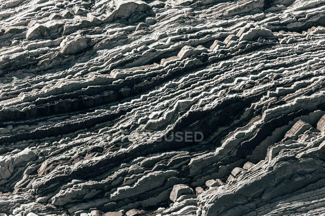 Gros plan de la surface pierreuse rugueuse sur une journée ensoleillée dans la nature — Photo de stock