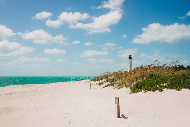 Lighthouse standing on beach — Stock Photo