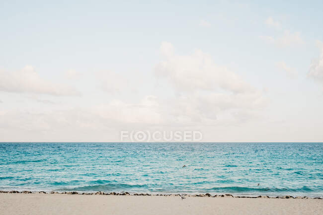 Clouds over waving sea — Stock Photo