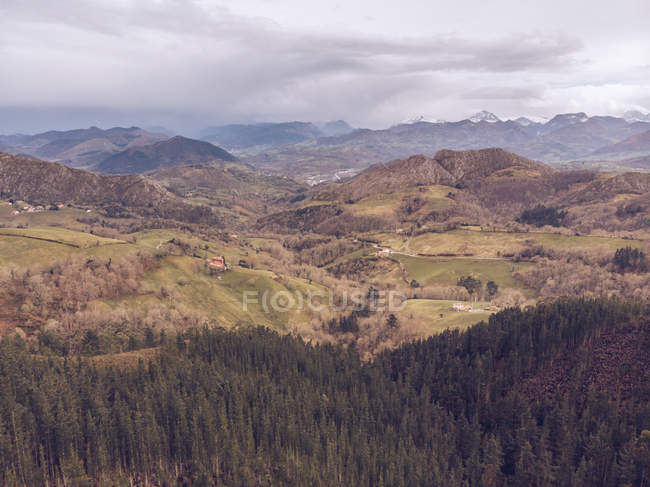 Picturesque drone view of majestic mountain ridge and hilly terrain on cloudy day in Asturias, Spain — Stock Photo