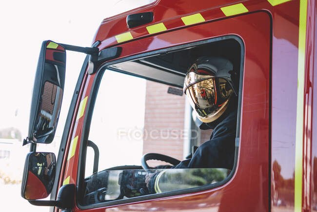Firemen driving inside an emergency vehicle. — Stock Photo