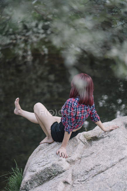Red haired girl rests by the river — Stock Photo